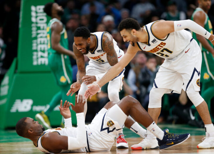Denver Nuggets guard Will Barton (5) and guard Jamal Murray (27) celebrate with center Paul Millsap (4) during the second half against the Boston Celtics at TD Garden.