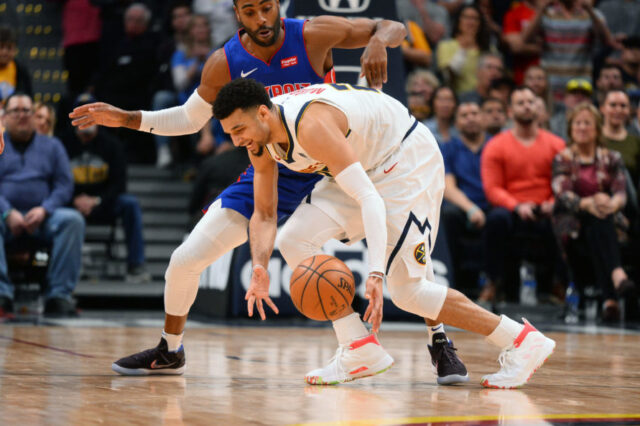 Detroit Pistons guard Wayne Ellington (top) pressures Denver Nuggets guard Jamal Murray (27) in the second half at the Pepsi Center.