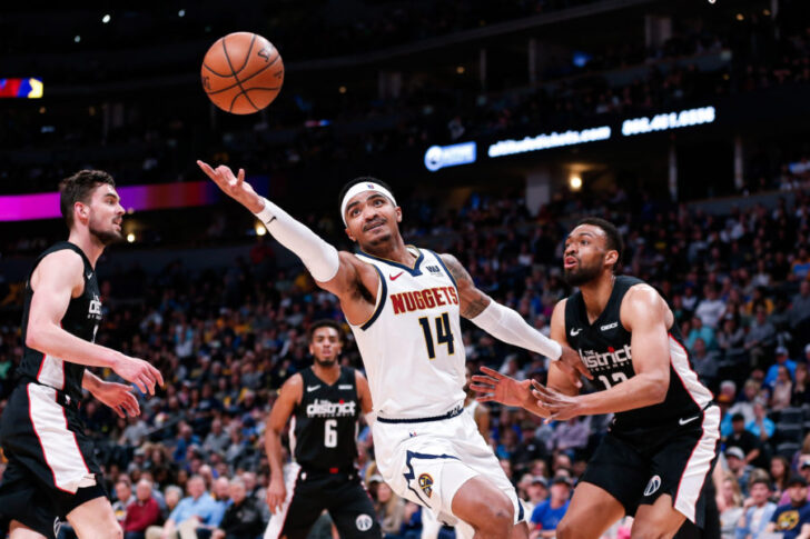 Denver Nuggets guard Gary Harris (14) grabs for a loose ball against Washington Wizards forward Jabari Parker (12) in the second quarter at the Pepsi Center.