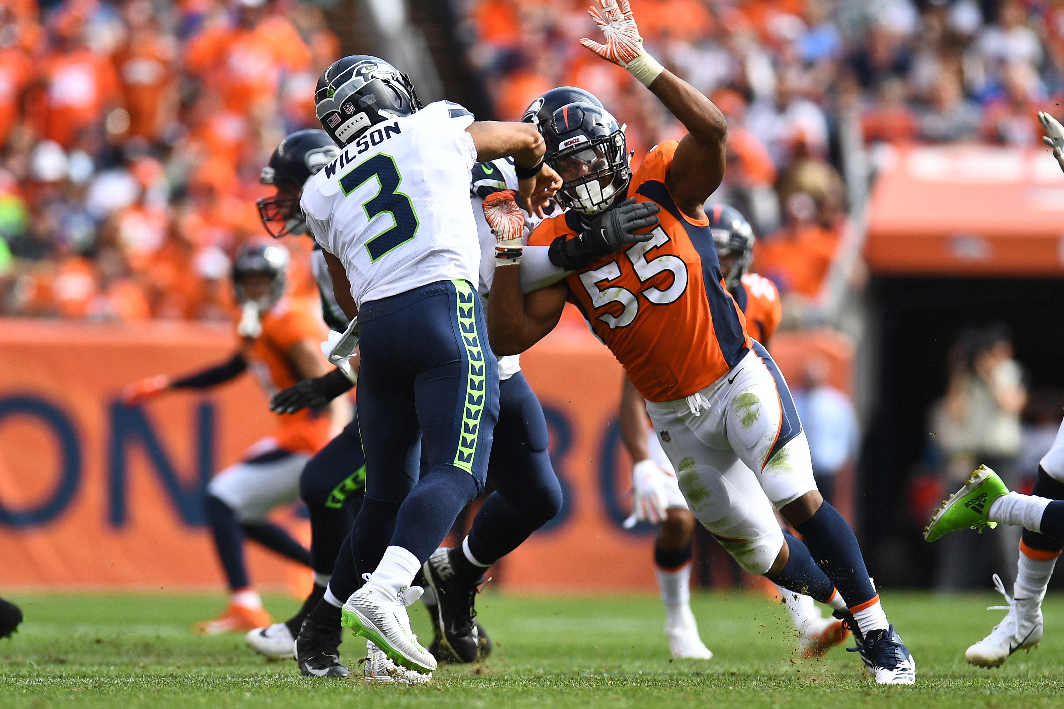 Denver Broncos outside linebacker Bradley Chubb (55) hurries Seattle Seahawks quarterback Russell Wilson (3) in the second quarter at Broncos Stadium at Mile High.