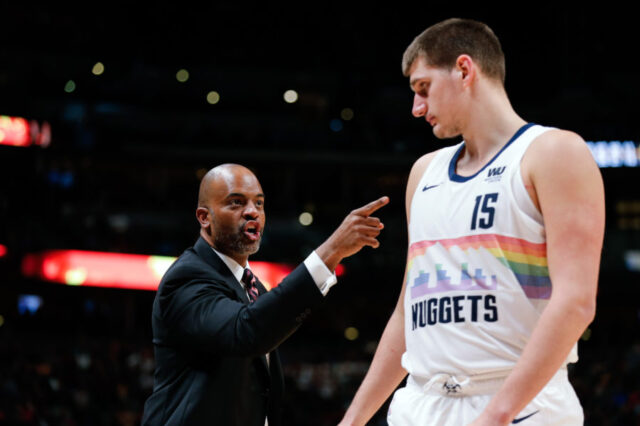 Denver Nuggets assistant coach Wes Unseld Jr. talks with center Nikola Jokic (15) in the fourth quarter against the Houston Rockets at the Pepsi Center.