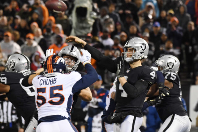 Oakland Raiders quarterback Derek Carr (4) throws a pass against the Denver Broncos in the first half at Oakland Coliseum.