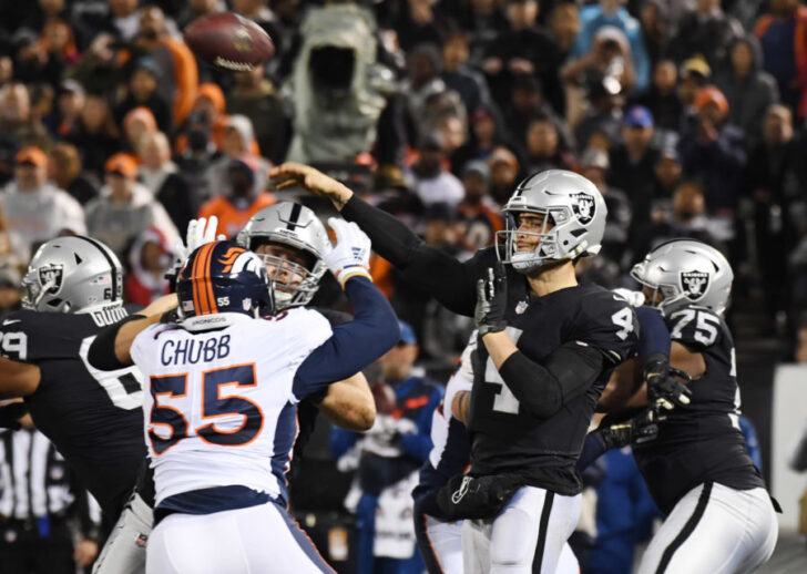Oakland Raiders quarterback Derek Carr (4) throws a pass against the Denver Broncos in the first half at Oakland Coliseum.