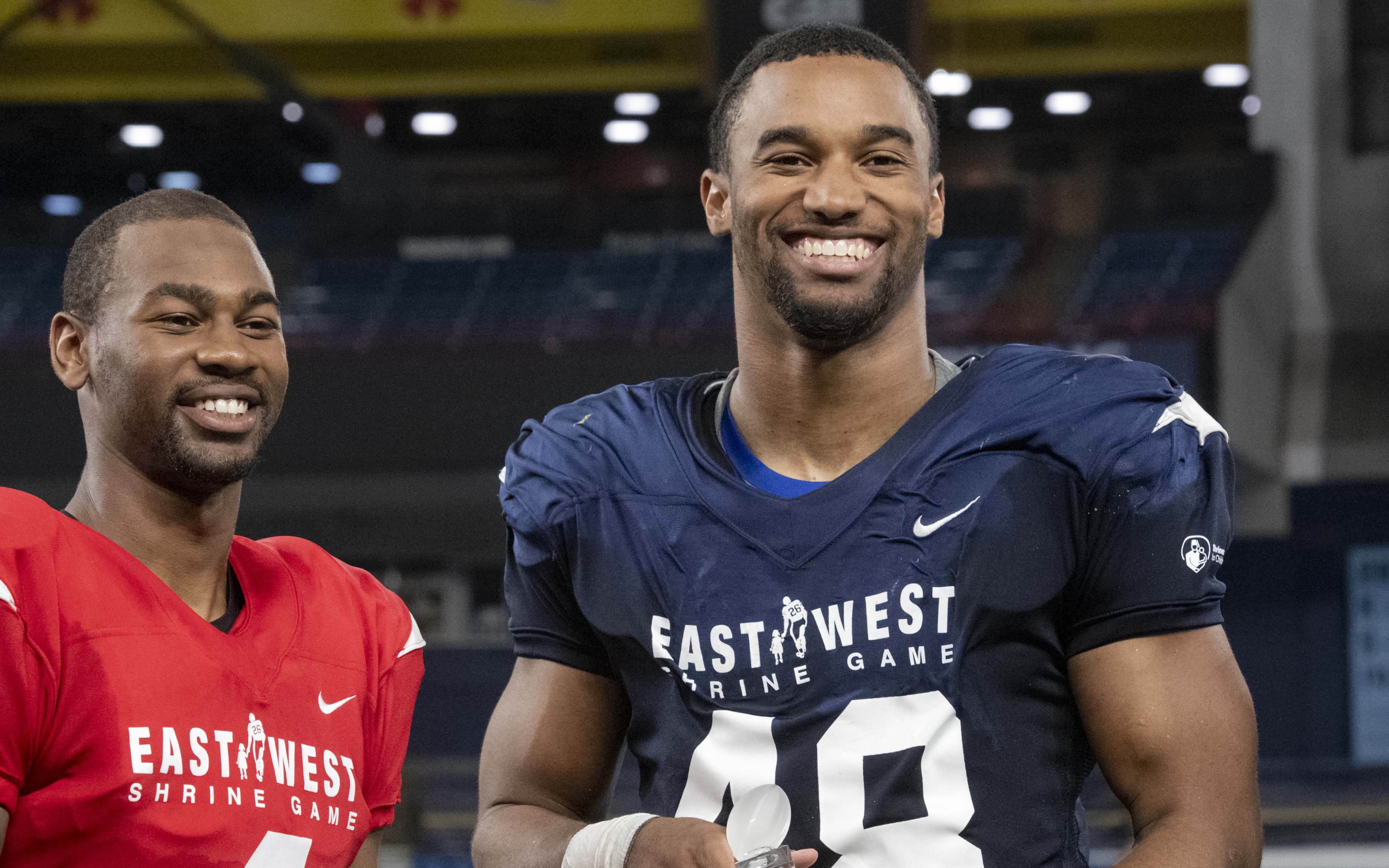 USATSI_12026000 Cropped Justin Hollins (right) receives an award as the defensive MVP of the East-West Shrine Game.