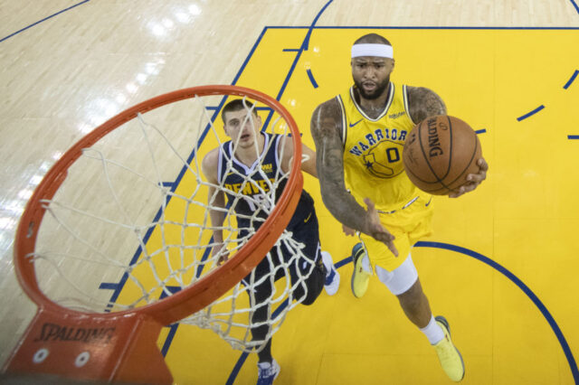 Golden State Warriors center DeMarcus Cousins (0) shoots the basketball against Denver Nuggets center Nikola Jokic (15) during the first half at Oracle Arena.