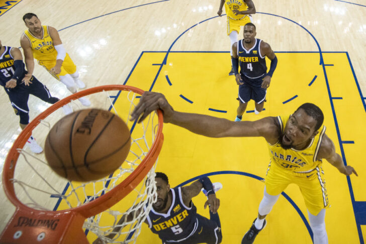 Golden State Warriors forward Kevin Durant (35) dunks the basketball against Denver Nuggets guard Will Barton (5) during the first half at Oracle Arena.