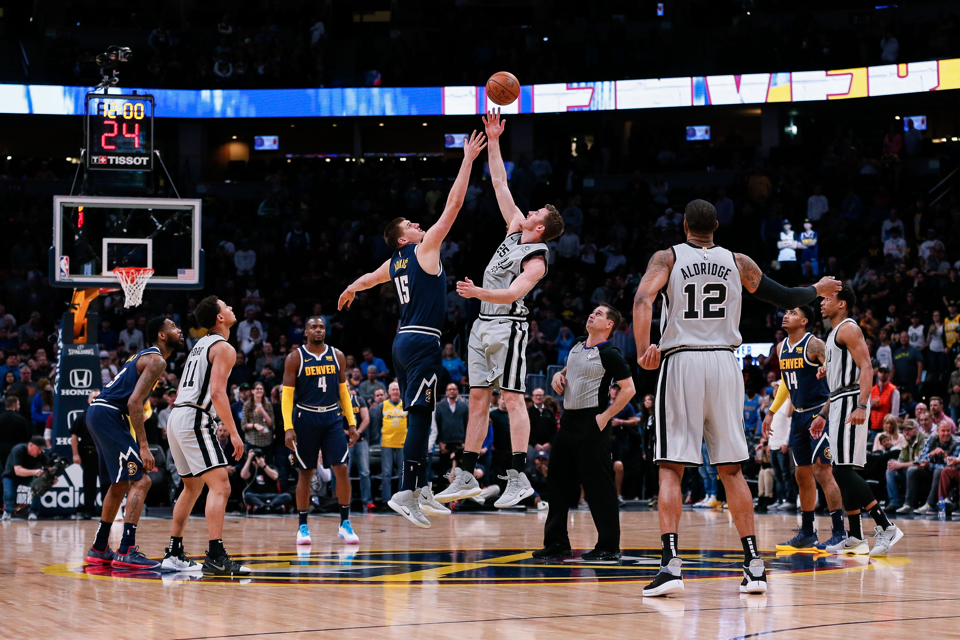 NBA: San Antonio Spurs at Denver Nuggets San Antonio Spurs center Jakob Poeltl (25) wins the tip off against Denver Nuggets center Nikola Jokic (15) in the first quarter at the Pepsi Center