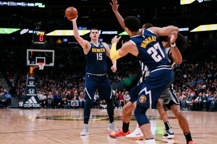 Denver Nuggets center Nikola Jokic (15) tries to pass to guard Jamal Murray (27) as he battles for position against San Antonio Spurs guard Patty Mills (8) in the second quarter at the Pepsi Center.
