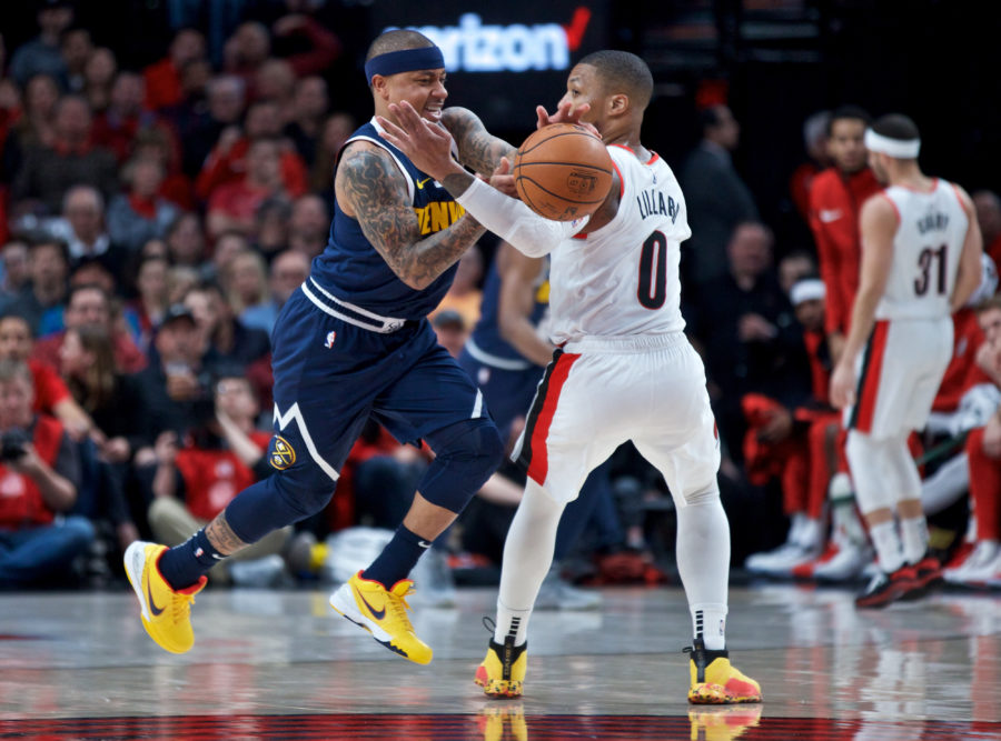Denver Nuggets guard Isaiah Thomas (0) steals the ball from Portland Trail Blazers guard Damian Lillard (0) during the first quarter at the Moda Center.