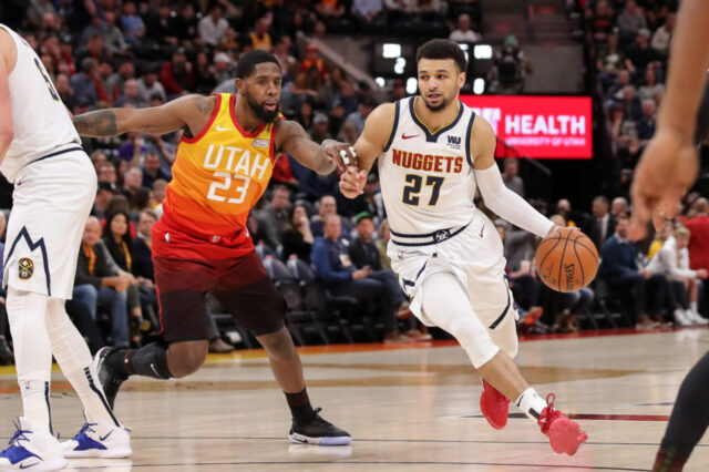Denver Nuggets guard Jamal Murray (27) dribbles the ball around Utah Jazz forward Royce O'Neale (23) during the first quarter at Vivint Smart Home Arena.