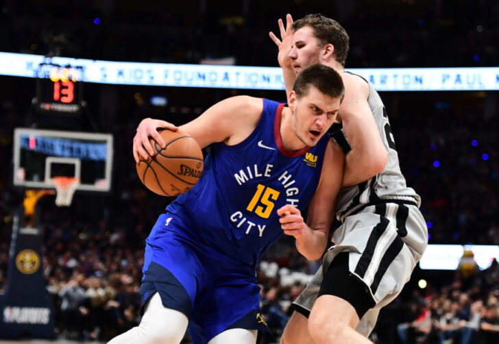 Denver Nuggets center Nikola Jokic (15) drives by San Antonio Spurs center Jakob Poeltl (25) in the second quarter in the first round of the 2019 NBA Playoffs at Pepsi Center.