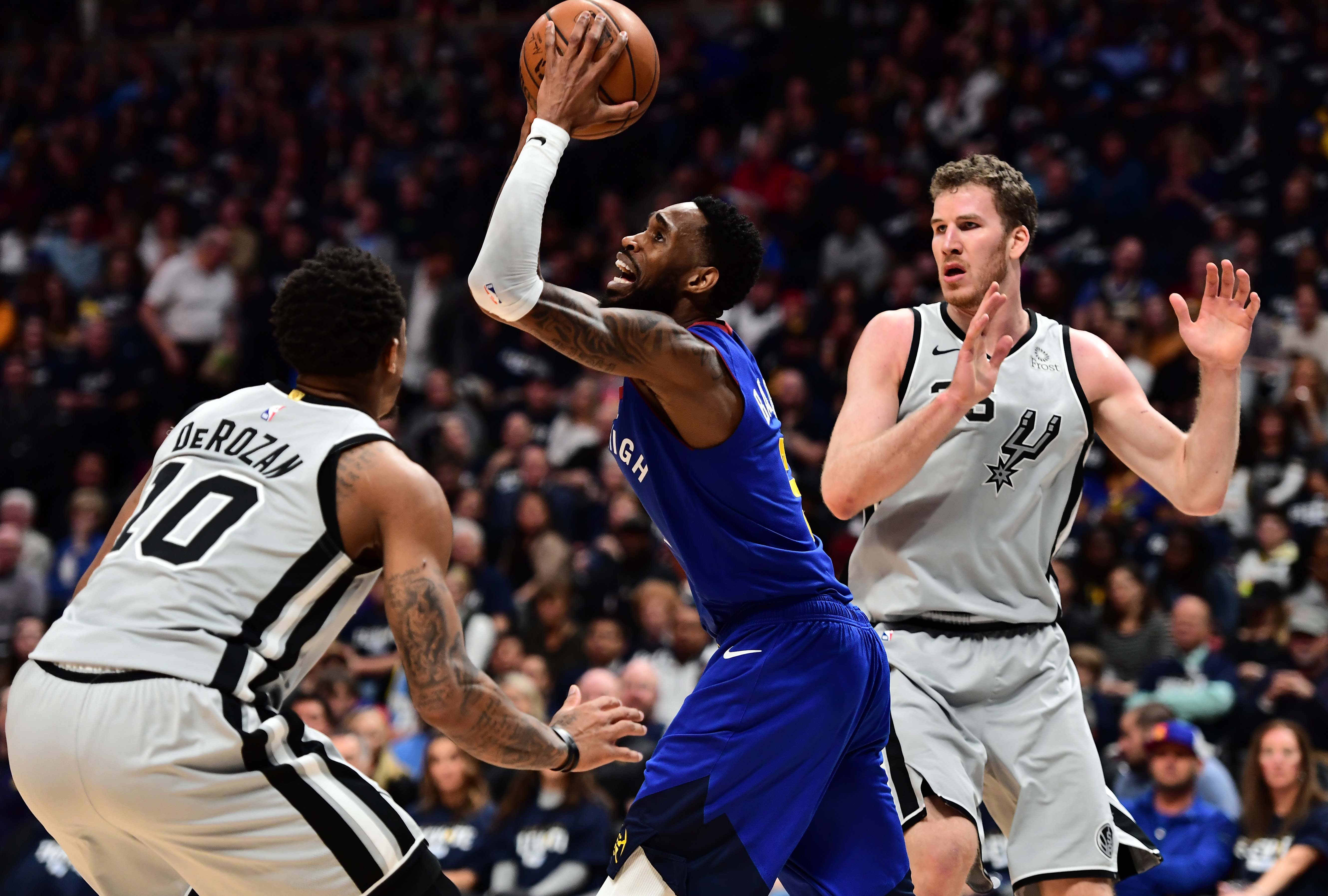 NBA: Playoffs-San Antonio Spurs at Denver Nuggets Denver Nuggets guard Will Barton (5) shoots over San Antonio Spurs guard DeMar DeRozan (10) in the second quarter of the first round of the 2019 NBA Playoffs at Pepsi Center.