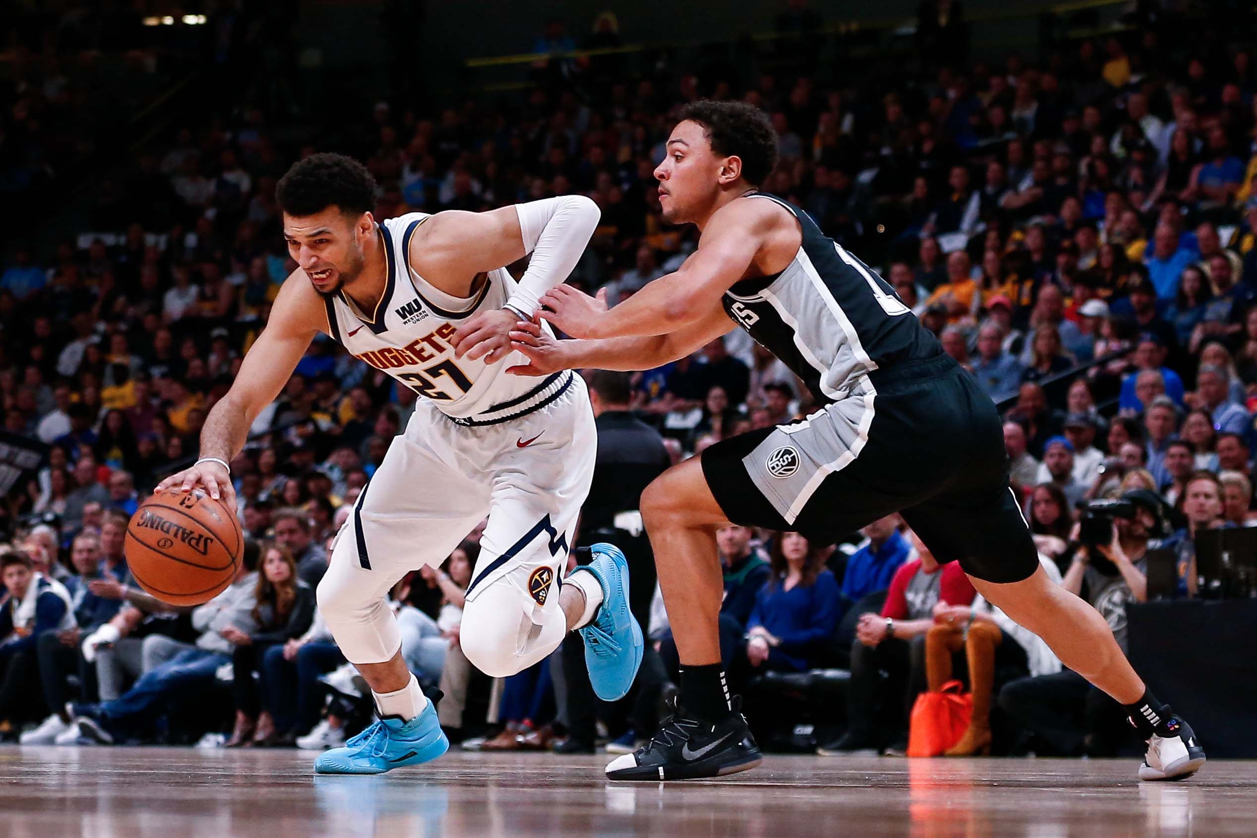 NBA: Playoffs-San Antonio Spurs at Denver Nuggets Denver Nuggets guard Jamal Murray (27) controls the ball as San Antonio Spurs guard Bryn Forbes (11) defends in the second quarter in game two of the first round of the 2019 NBA Playoffs at the Pepsi Center.