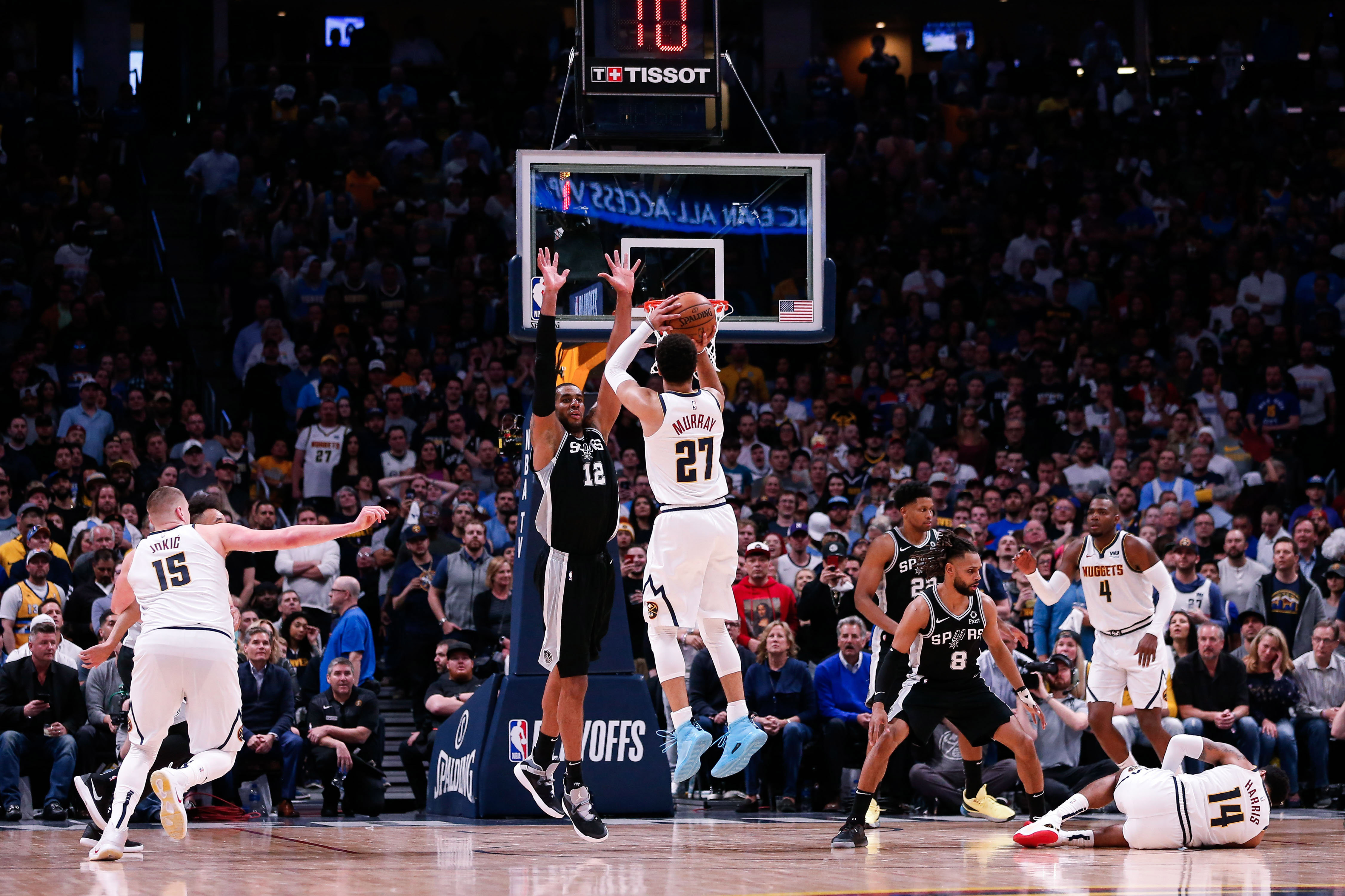 NBA: Playoffs-San Antonio Spurs at Denver Nuggets Denver Nuggets guard Jamal Murray (27) attempts a shot against San Antonio Spurs center LaMarcus Aldridge (12) as center Nikola Jokic (15) looks on and guard Patty Mills (8) and forward Rudy Gay (22) defend against guard Gary Harris (14) and forward Paul Millsap (4) in the fourth quarter in game two of the first round of the 2019 NBA Playoffs at the Pepsi Center.