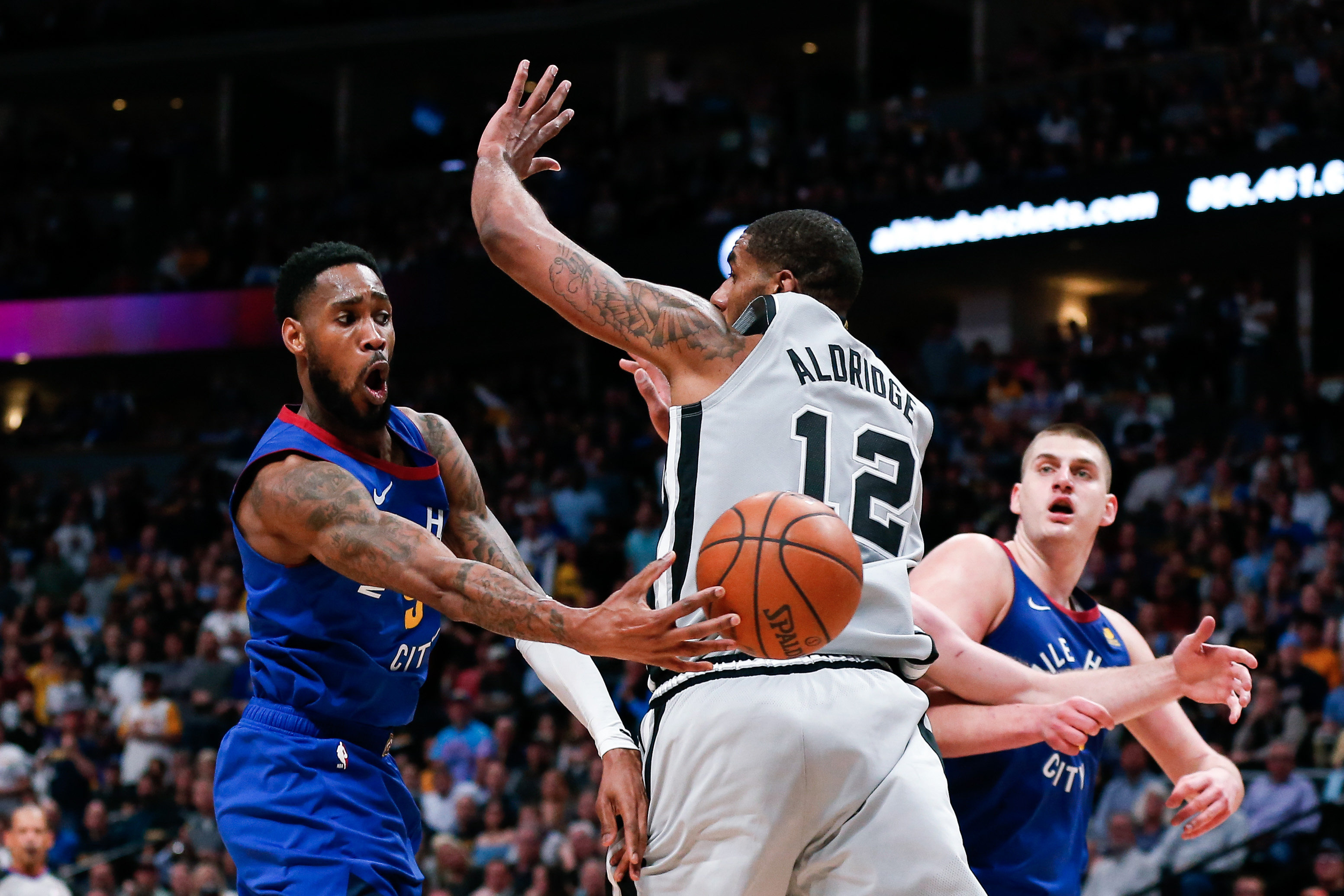 NBA: Playoffs-San Antonio Spurs at Denver Nuggets Denver Nuggets guard Will Barton (5) passes the ball to center Nikola Jokic (15) around San Antonio Spurs center LaMarcus Aldridge (12) in the second quarter at the Pepsi Center.