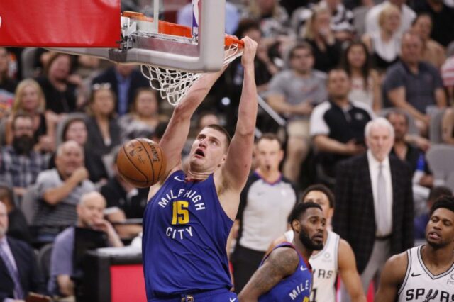 Denver Nuggets center Nikola Jokic (15) dunks the ball against the San Antonio Spurs in game six of the first round of the 2019 NBA Playoffs at AT&T Center.