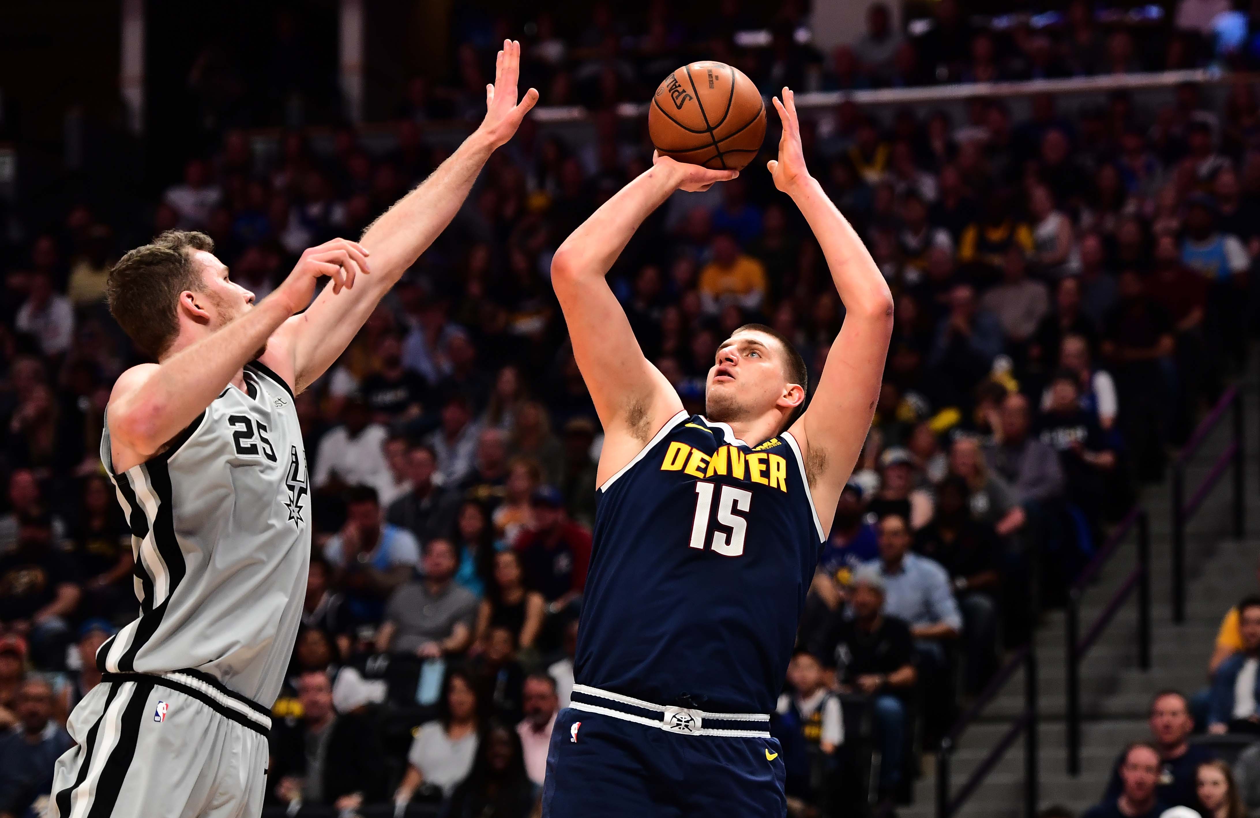 NBA: Playoffs-San Antonio Spurs at Denver Nuggets Denver Nuggets center Nikola Jokic (15) shoots over San Antonio Spurs center Jakob Poeltl (25) in the first quarter in game seven of the first round of the 2019 NBA Playoffs at the Pepsi Center.