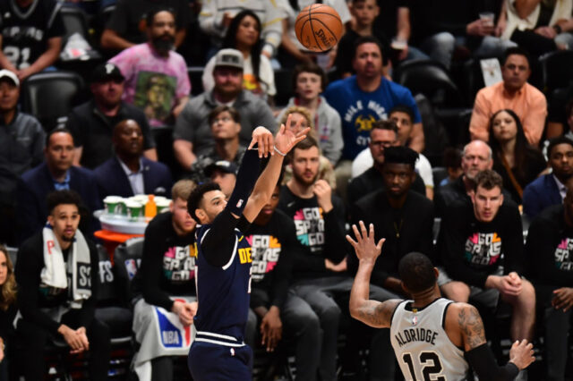 Denver Nuggets guard Jamal Murray (27) shoots over San Antonio Spurs center LaMarcus Aldridge (12) in the fourth quarter in game seven of the first round of the 2019 NBA Playoffs at the Pepsi Center.