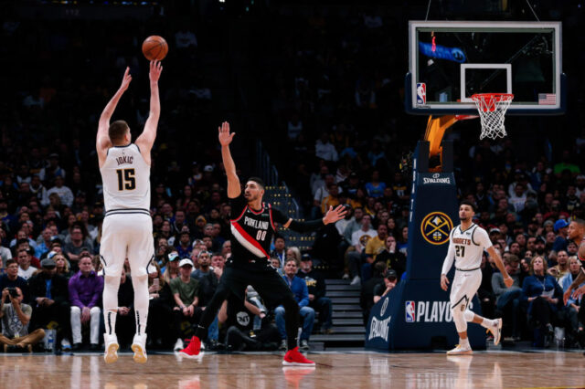 Denver Nuggets center Nikola Jokic (15) shoots the ball over Portland Trail Blazers center Enes Kanter (00) in the second quarter in game one of the second round of the 2019 NBA Playoffs at the Pepsi Center.
