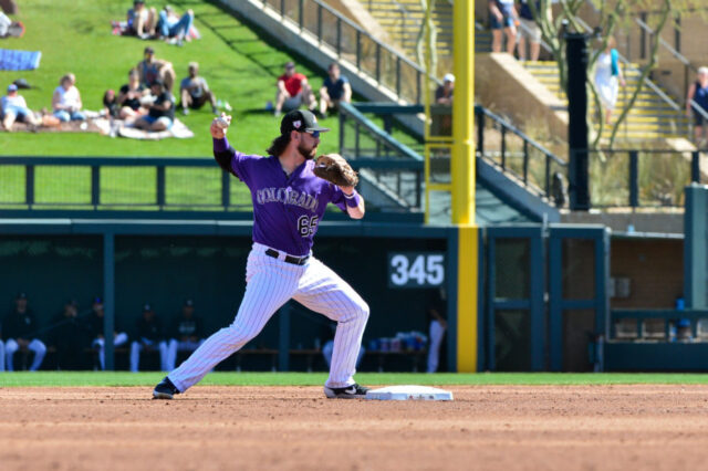 Colorado Rockies shortstop Brendan Rodgers (65) throws to first base during he second inning against the Milwaukee Brewers at Salt River Fields at Talking Stick.