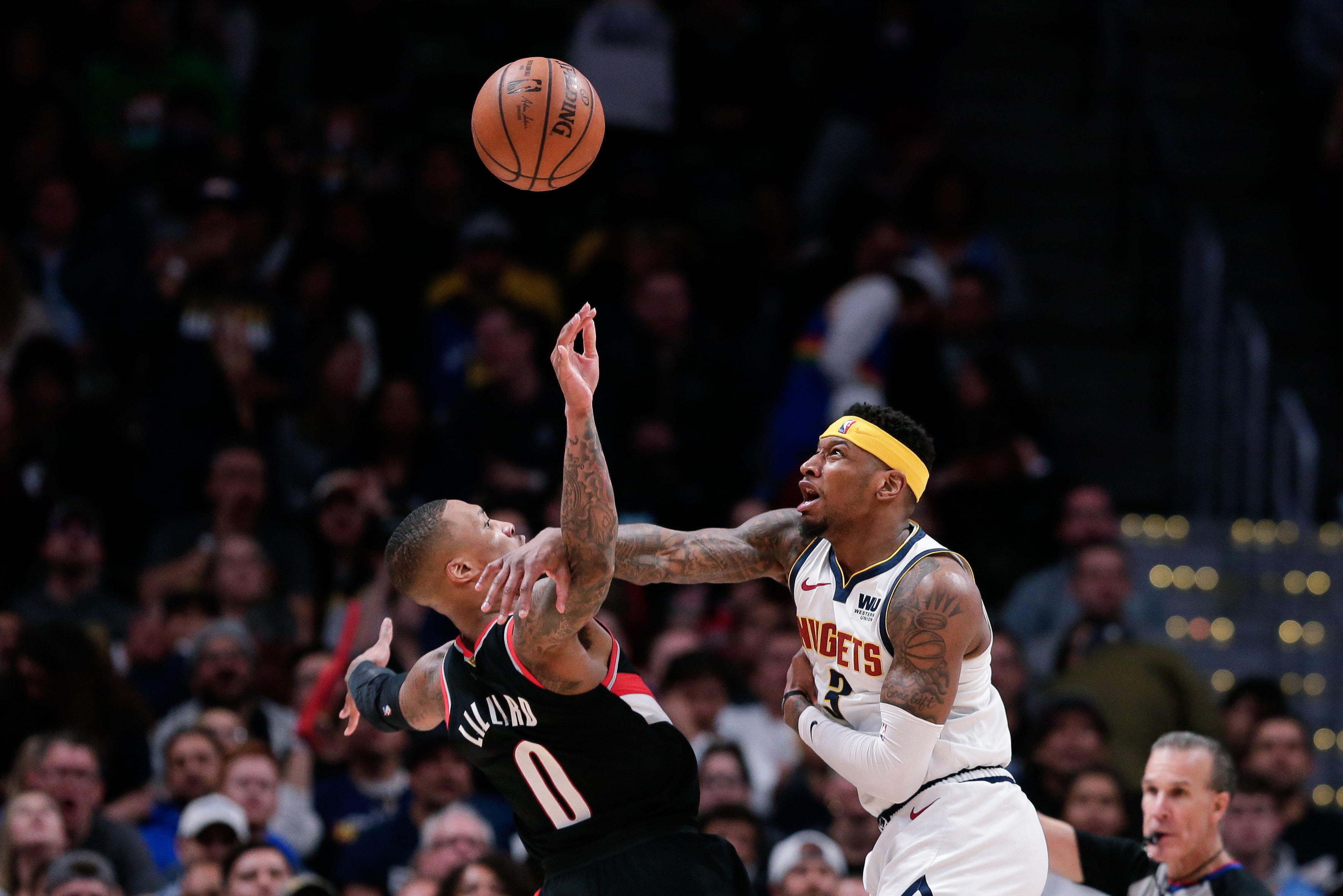 NBA: Playoffs-Portland Trail Blazers at Denver Nuggets Denver Nuggets forward Torrey Craig (3) fouls Portland Trail Blazers guard Damian Lillard (0) in the third quarter in game one of the second round of the 2019 NBA Playoffs at the Pepsi Center.