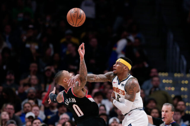 Denver Nuggets forward Torrey Craig (3) fouls Portland Trail Blazers guard Damian Lillard (0) in the third quarter in game one of the second round of the 2019 NBA Playoffs at the Pepsi Center.