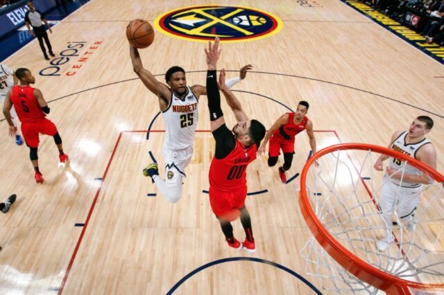 Denver Nuggets guard Malik Beasley (25) drives to the net against Portland Trail Blazers center Enes Kanter (00) as guard CJ McCollum (3) and center Nikola Jokic (15) look on in the third quarter in game two of the second round of the 2019 NBA Playoffs at the Pepsi Center.