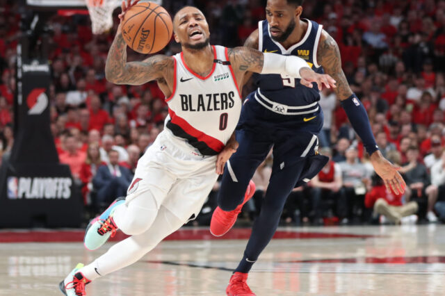 Portland Trail Blazers guard Damian Lillard (0) drives against Denver Nuggets guard Will Barton (5) in the second half of game four of the second round of the 2019 NBA Playoffs at Moda Center.