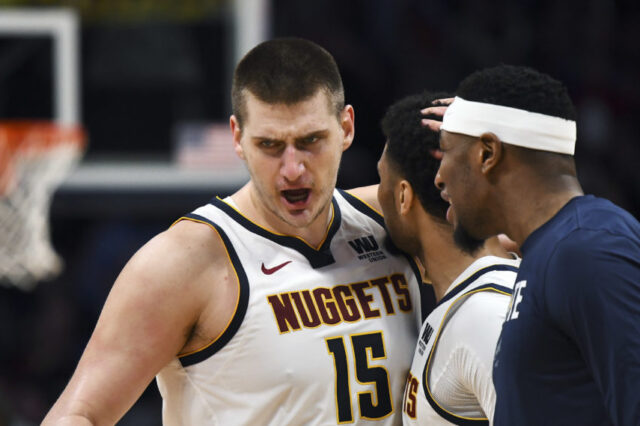 Denver Nuggets center Nikola Jokic (15) reacts following a score with guard Jamal Murray (27) and forward Torrey Craig (3) in the second quarter against the Portland Trail Blazers in game five of the second round of the 2019 NBA Playoffs at Pepsi Center.