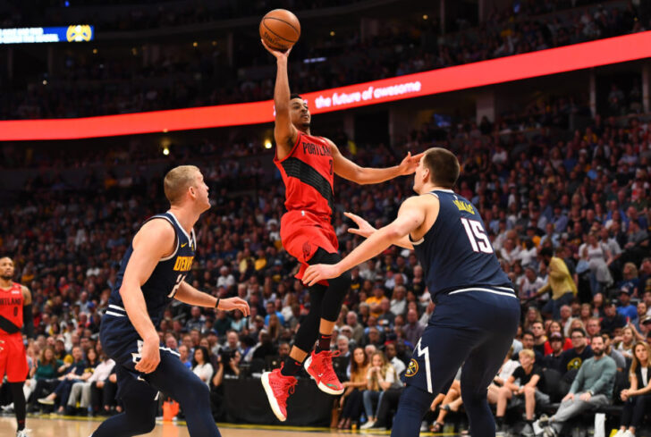 Portland Trail Blazers guard CJ McCollum (3) shoots over Denver Nuggets forward Mason Plumlee (24) and center Nikola Jokic (15) in the second quarter in game seven of the second round of the 2019 NBA Playoffs at Pepsi Center.