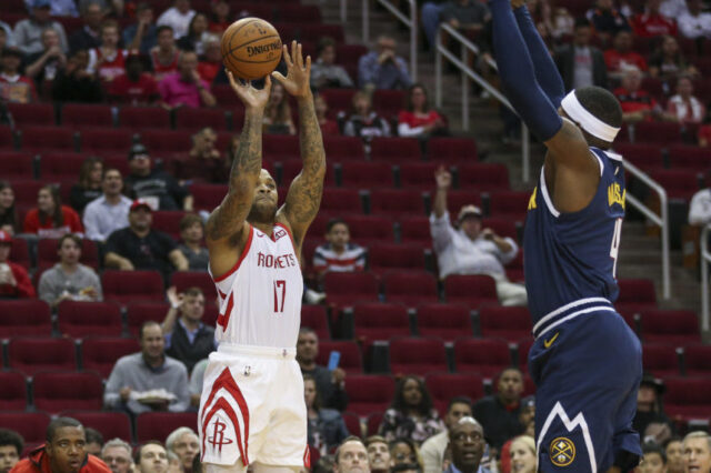 Houston Rockets forward PJ Tucker (17) shoots the ball against Denver Nuggets forward Paul Millsap (4) during the first quarter at Toyota Center.