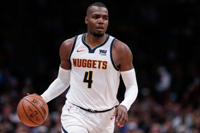 Denver Nuggets forward Paul Millsap (4) dribbles the ball in the third quarter against the Portland Trail Blazers in game one of the second round of the 2019 NBA Playoffs at the Pepsi Center.