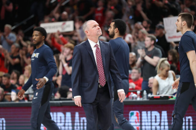 Denver Nuggets head coach Michael Malone looks at the scoreboard during a timeout Portland Trail Blazers in the first half of game three of the second round of the 2019 NBA Playoffs at Moda Center.