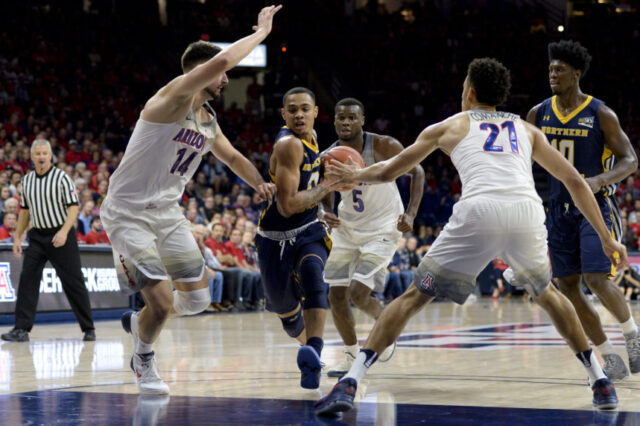 Northern Colorado Bears guard Jordan Davis (0) drives to the basket as Arizona Wildcats center Dusan Ristic (14) and center Chance Comanche (21) defends during the