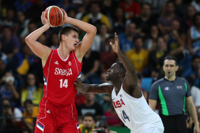 Rio de Janeiro, Brazil; Serbia center Nikola Jokic (14) looks to pass while guarded by United States forward Draymond Green (14) during the game in the preliminary round of the Rio 2016 Summer Olympic Games at Carioca Arena 1.