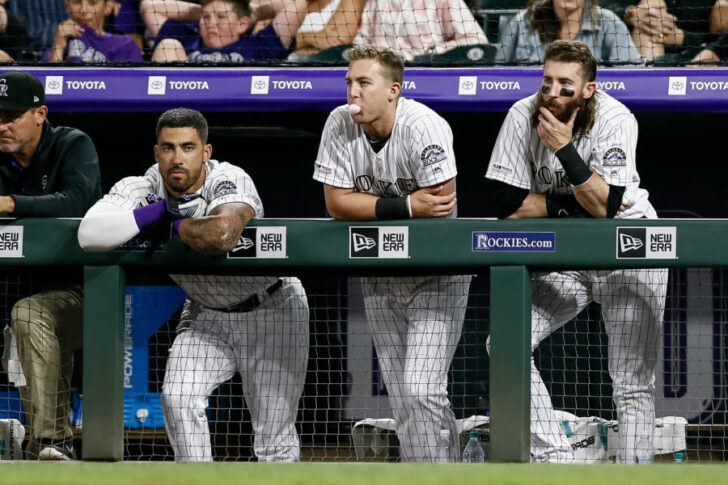 Colorado Rockies center fielder Ian Desmond (20) and second baseman Ryan McMahon (24) and right fielder Charlie Blackmon (19) look on from the dugout in the ninth inning against the San Francisco Giants at Coors Field.