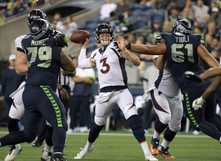 Denver Broncos quarterback Drew Lock (3) throws a pass under pressure from Seattle Seahawks defensive tackle Jay-Tee Tiuli (61) and nose tackle Bryan Mone (79) in the fourth quarter at CenturyLink Field. The Seahawks won 22-14.
