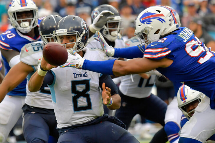 Tennessee Titans quarterback Marcus Mariota (8) shuttles the ball out to Titans running back Derrick Henry (22) (not pictured) against Buffalo Bills defensive end Darryl Johnson (92) during the second half at Nissan Stadium.