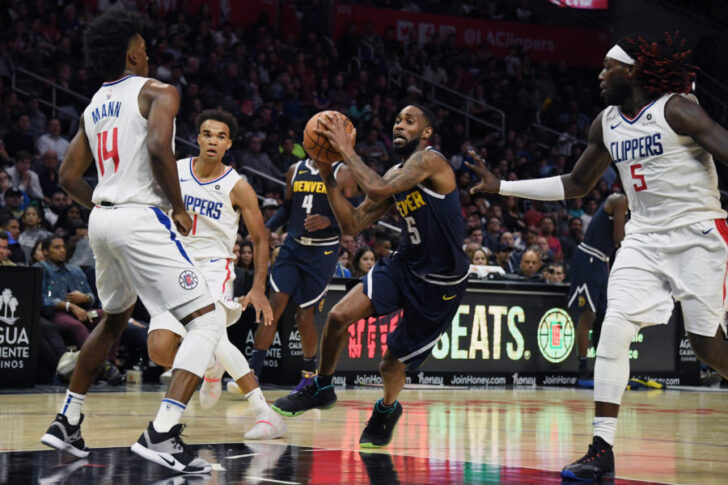 Denver Nuggets guard Will Barton (5) drives between LA Clippers guard Terance Mann (14) and forward Montrezl Harrell (5) during the second half at Staples Center.
