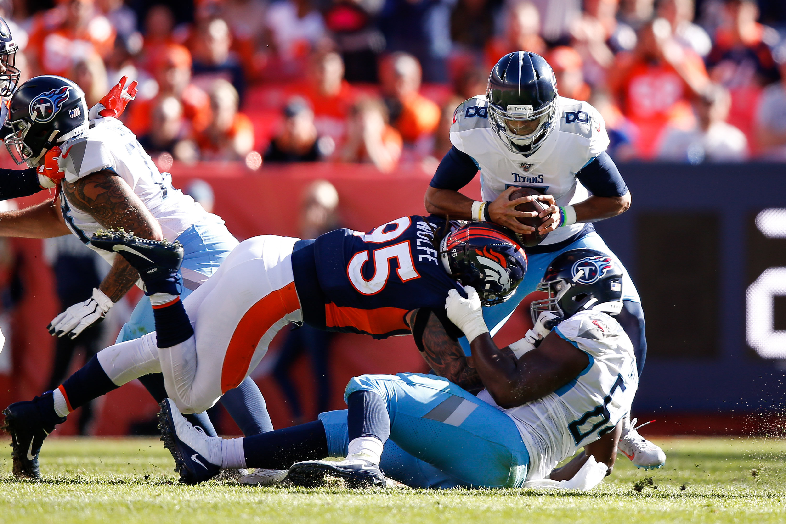 NFL: Tennessee Titans at Denver Broncos Tennessee Titans quarterback Marcus Mariota (8) is sacked by Denver Broncos defensive end Derek Wolfe (95) as guard Nate Davis (64) defends in the second quarter at Empower Field at Mile High.