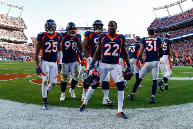 Denver Broncos defensive back Kareem Jackson (22) celebrates with teammates after his interception in the fourth quarter against the Tennessee Titans at Empower Field at Mile High.