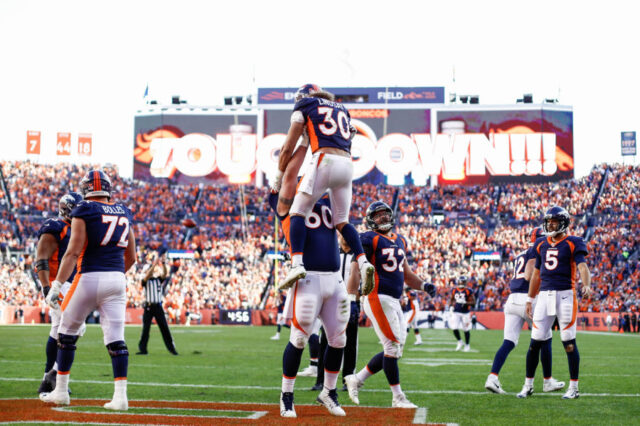Denver Broncos guard Connor McGovern (60) celebrates the touchdown of running back Phillip Lindsay (30) in the third quarter against the Tennessee Titans at Empower Field at Mile High.