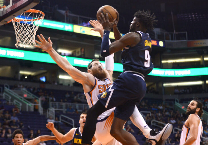 Denver Nuggets forward Jerami Grant (9) is fouled driving to the basket by Phoenix Suns center Aron Baynes (46) during the second half at Talking Stick Resort Arena.