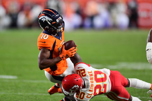 Kansas City Chiefs cornerback Morris Claiborne (20) tackles Denver Broncos wide receiver Emmanuel Sanders (10) in the second quarter at Empower Field at Mile High.