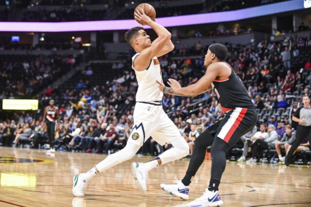 Denver Nuggets forward Michael Porter Jr. (1) makes a move around Portland Trail Blazers guard Troy Caupain (10) during the second half at Pepsi Center.
