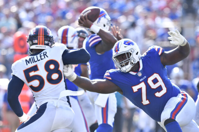 Buffalo Bills offensive tackle Jordan Mills (79) tries to keep Denver Broncos outside linebacker Von Miller (58) off of his quarterback on a pass rush during the fourth quarter of a game at New Era Field.