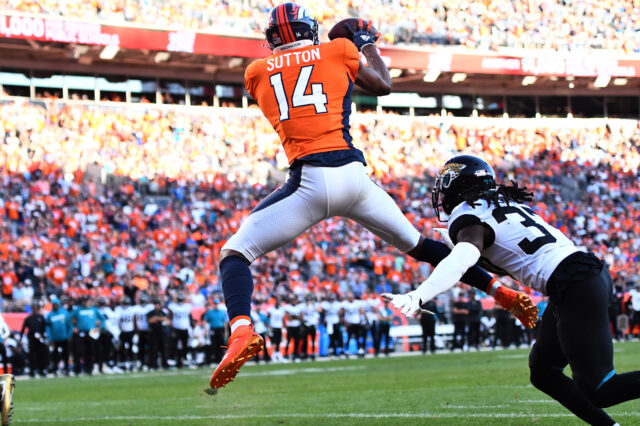 Denver Broncos wide receiver Courtland Sutton (14) pulls in a touchdown past Jacksonville Jaguars cornerback Tre Herndon (37) in the fourth quarter at Empower Field at Mile High.