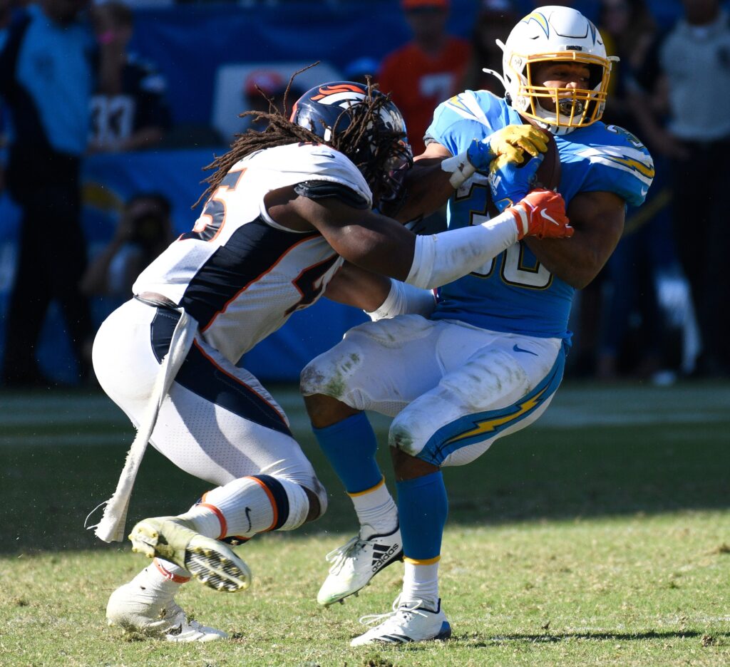 Denver Broncos linebacker A.J. Johnson (45) stops Los Angeles Chargers running back Austin Ekeler (30) after a short gain in the 4th quarter at Dignity Health Sports Park.