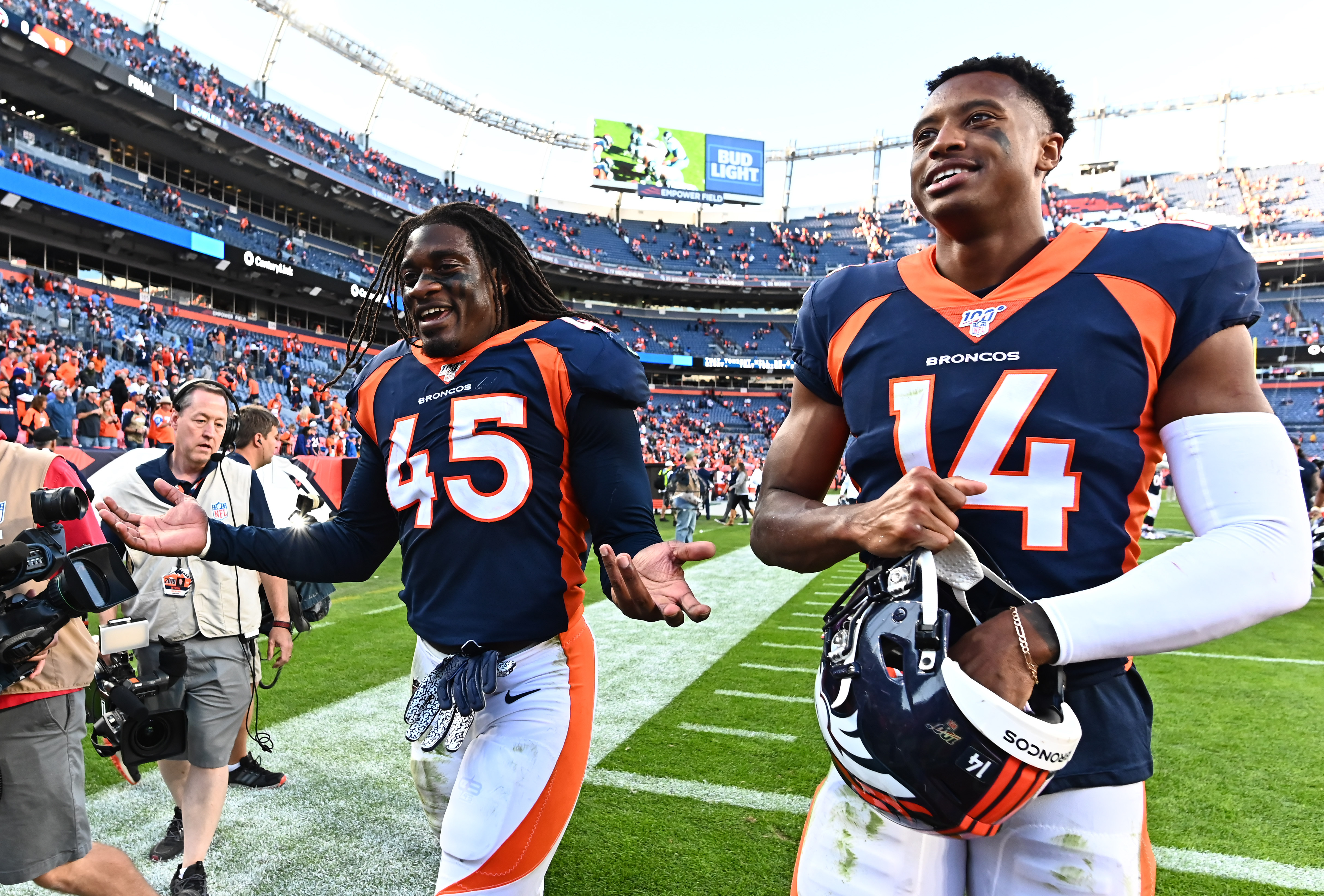 Denver Broncos linebacker Alexander Johnson (45) and wide receiver Courtland Sutton (14) following the win over the Tennessee Titans the at Empower Field at Mile High.