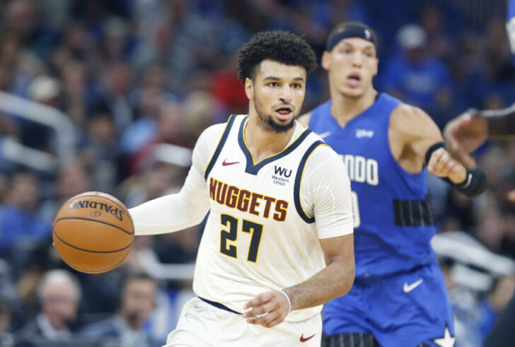 Denver Nuggets guard Jamal Murray (27) brings the ball down court past Orlando Magic forward Aaron Gordon (00) during the second quarter at Amway Center.